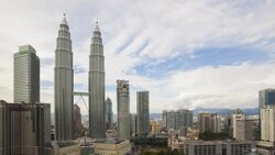 Clouds drift through the sky over the Petronas Twin Towers. Stock Footage