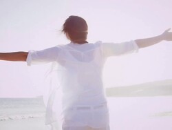 Woman spinning on beach Stock Footage