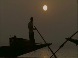MCU Silhouetted fishing boats moving through frame, Sunderbans, India Stock Footage