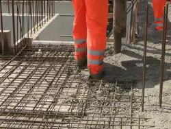 CU Shot of workmen filling cement concrete at house construction, building site / Hermeskeil, Rhineland Palatinate, Germany Stock Footage