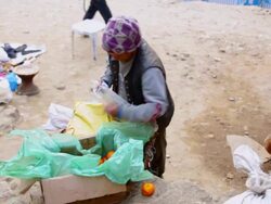 MS Shot over citrus merchant packs oranges in Namche Bazarre / Namche, Nepal Stock Footage
