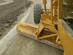 Grader Smoothing Gravel Surface for Asphalt Road Stock Footage