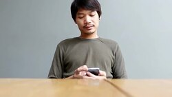 Young man playing smartphone at home Stock Footage