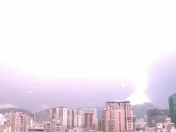 Large bolt of lightning hits mountain top at night, Hong Kong Stock Footage