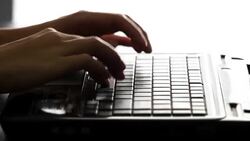 Female hands typing on a laptop keyboard Stock Footage