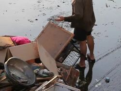 Man throwing household waste from flood situation. Stock Footage