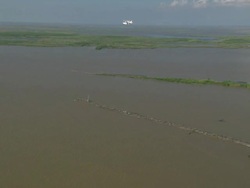 AERIAL WS Seaplane flying over cargo ship in delta gulf / New Orleans, Louisiana, United States Stock Footage