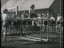 Girls exercise, have gym lessons and practice military organisation. France, 1942 Stock Footage