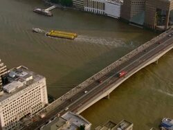 Aerial wide shot pan London Bridge during evening rush hour / London, England Stock Footage