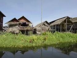 MS POV View of Boat riding along floating village / Ywama, Shan State, Myanmar Stock Footage