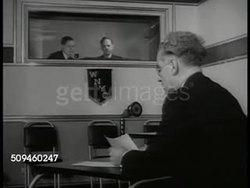 1938: NYPD DETECTIVES: REPRISAL: Detective talking w/ man in rooming house holding information sheet. WNYC: INT Radio studio SOT announcer broadcasting Public Service Announcement on missing person listing for 19 year old woman from Bronx. Instructional Video