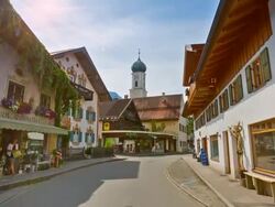 Central Oberammergau, steady cam along main road towards church Stock Footage