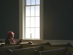 WS Senior woman praying in church near window / Port Gamble, Washington State, USA Stock Footage
