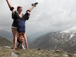 Teenage boy takes pictures of teenage girls doing handstand Stock Footage