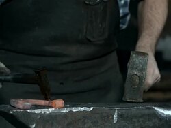 HD Super Slow-Mo: Blacksmith Making Nail Hole In A Horseshoe Stock Footage
