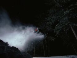 WS SLO MO Snowmobile jumping in snow covered forest / Mammoth Lakes, California, USA Stock Footage