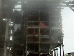 MS  Steel skeleton of building is demolished in controlled implosion using explosives andand  dissappearing cloud of dust / Vancouver, British Columbia, Canada Stock Footage