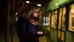 Young Woman Using Digital Tablet on Tram Station Stock Footage