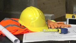 Blueprints, plans, hard hat and construction tools on table: DOLLY Stock Footage
