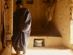 A man reading poetry in the library of Chinguetti Stock Footage