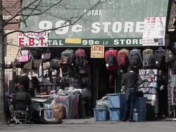 MS Shot of 99 cents store in Harlem with various suitcases and bags are seen hanging above shop entry / New York, United States Stock Footage