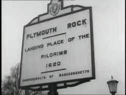 A sign indicates Plymouth Rock, Massachusetts. News Clip