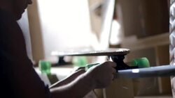 Shop owner hangs price tags on new skateboards and catalogs info on laptop computer Stock Footage