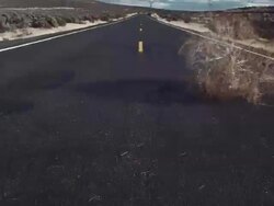 WS TU Tumbleweed blowing across road / Zillah, Washington, USA  Stock Footage