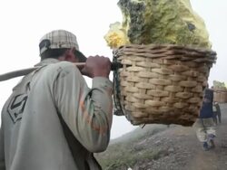 MS POV View of miners feet climbing the Ijen volcano among toxic gases carrying solid sulfur / Ijen, Java, Indonesia Stock Footage