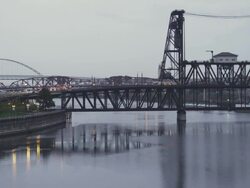 WS View of Three bridges of Freemont, Broadway and Steel bridge cross Willamette River in Portland, Oregon at dusk on rainy day / Portland, Oregon, United States  Stock Footage