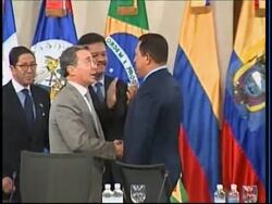 Colombia President Uribe shakes hands with Chavez, Correa News Clip