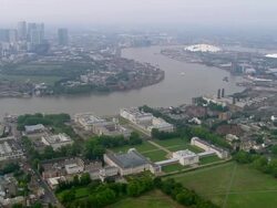 Aerial wide shot pan Greenwich Palace and Royal Naval Hospital with Thames and cityscape / London Stock Footage