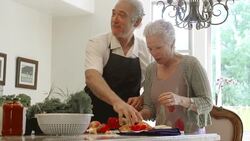SLOW MOTION - Fun Mature Preparing Food in Kitchen. Stock Footage