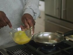 MS TD TU Dad putting butter in skillet then scrambles eggs / Dallas, Texas, USA Stock Footage
