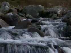Low angle water flowing over rocks and boulders in mountain stream, Brecon Beacons, Wales Stock Footage