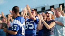 Stadium crowd cheers at football game, various high-fives Stock Footage