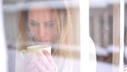 Woman having a tea or coffee on snowy day. Stock Footage