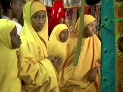 Group of girls dressed in yellow at market Stock Footage