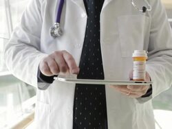 MS Middle aged doctor using tablet device inside hospital / Minneapolis, Minnesota, United States Stock Footage