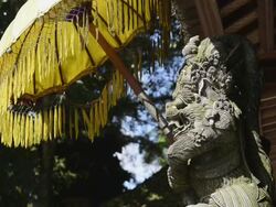 MS Shot of Temple guardian figure with temple umbrella at Pura Tirta Empul / Tampaksiring, Bali, Indonesia Stock Footage