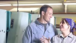 Three workers in manufacturing plant talking, laughing Stock Footage