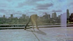 Vintage film footage of young man spraypainting graffiti wall and throwing paint can in slow motion Stock Footage