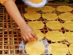 MS SLO MO Shot of woman hands placing cassava crackers on bamboo panel / Luang Prabang, Laos Stock Footage