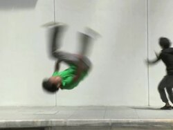 WS SLOMO Four young men do flips and somersaults in street, Parkour/Singapore Stock Footage