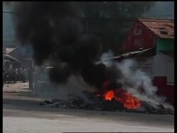 Violence breaks out at pro-Aristide demo News Clip