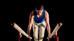 SLO MO Gymnast moving from L-sit position Stock Footage