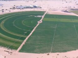Aerial irrigation boom across circular agricultural fields in Negev Desert, Negev, Israel Stock Footage