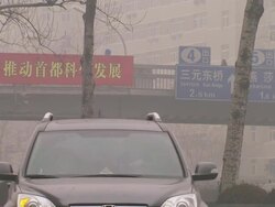 Traffic on Beijing roads on smoggy day News Clip
