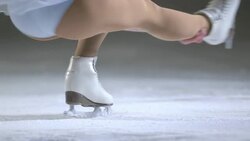 SLO MO Female figure skater performing a sit spin Stock Footage