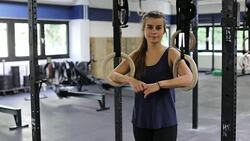 Confident woman with gymnastics rings in gym Stock Footage